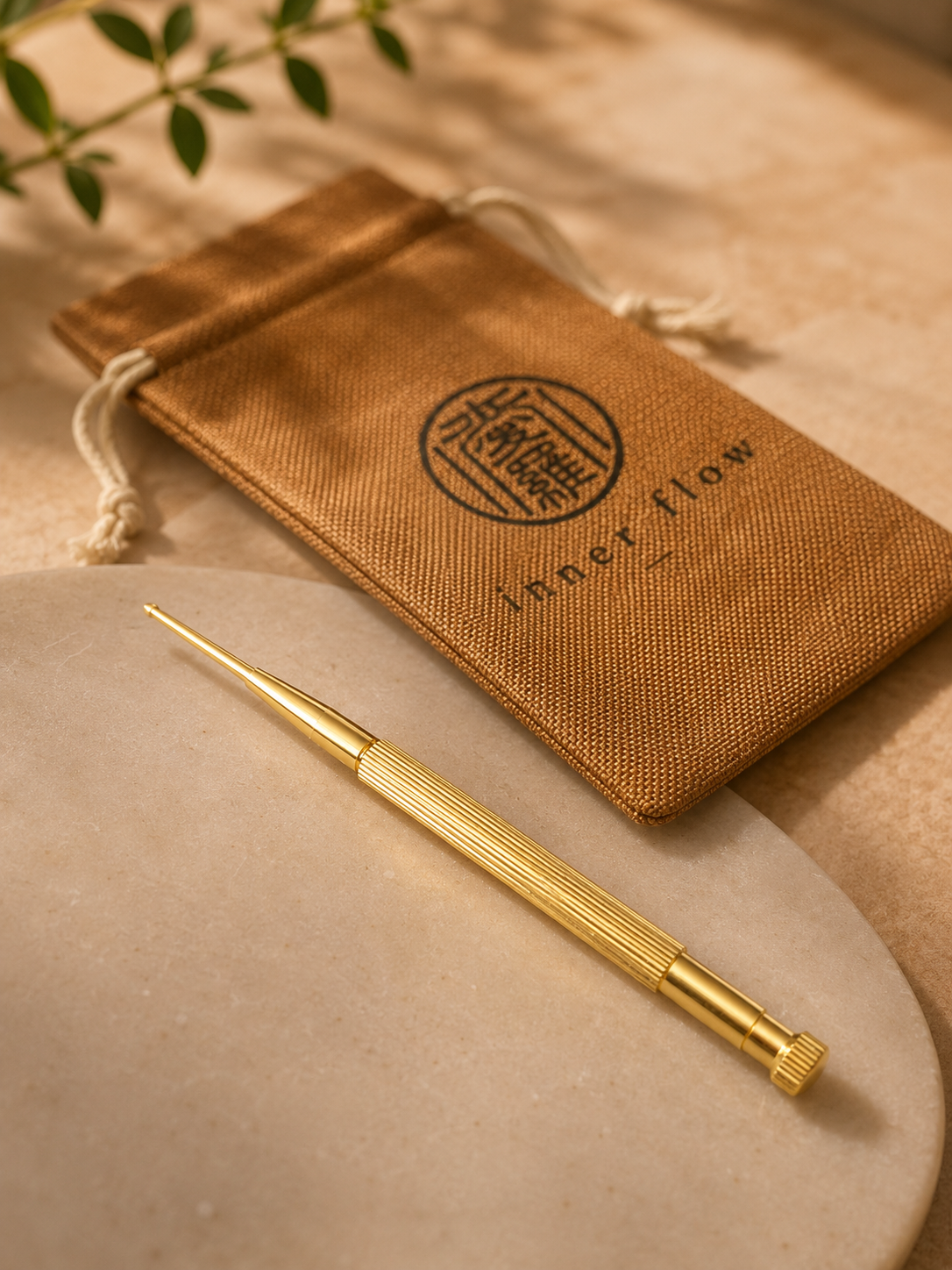 Gold acupressure pen with the Inner Flow pouch