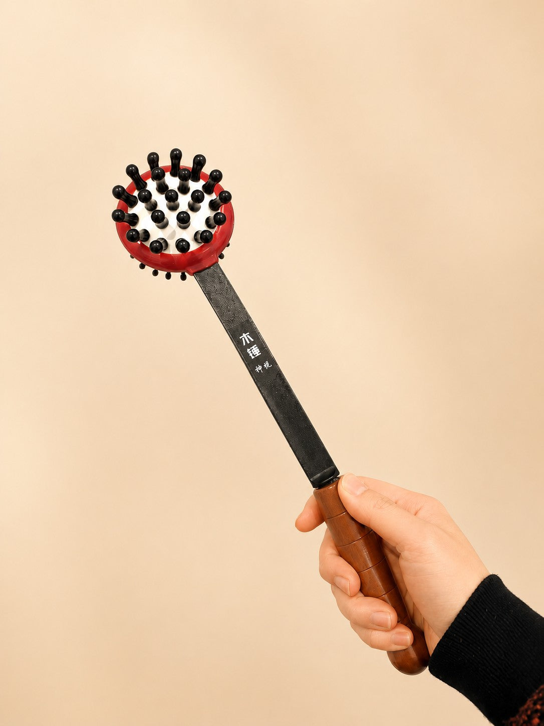 The Tapping Stick in the Small size, held in the hand