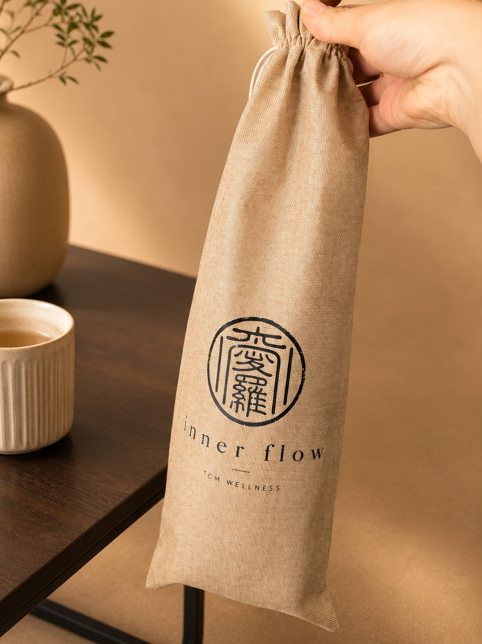 The Small tapping stick in its hand-stamped Inner Flow linen pouch